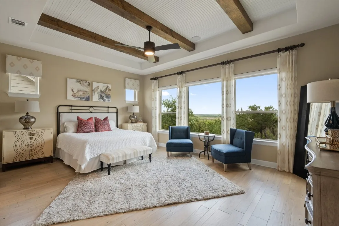 a spacious bedroom with a bed couch and a large window