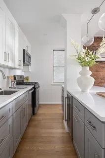 a kitchen with sink and cabinets