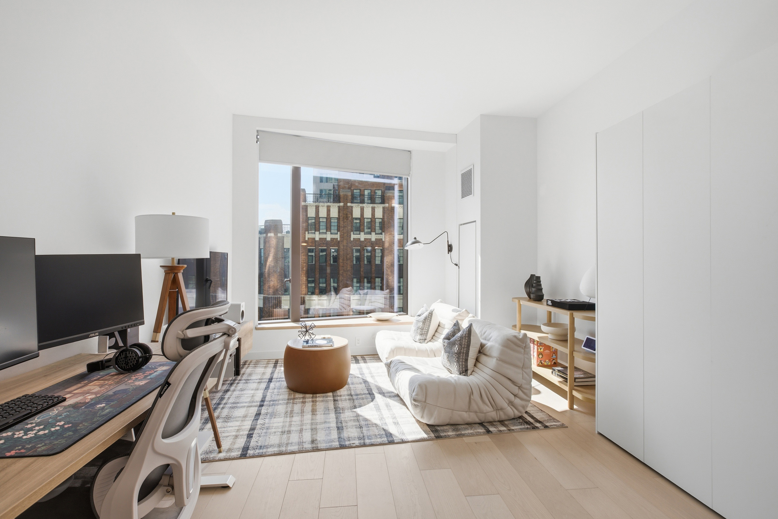 11 Hoyt Street, Unit 14M Brooklyn, NY 11201 - Photo 1 of 22 a bedroom with furniture and a flat screen tv