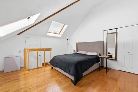 a bedroom with a bed and a dresser