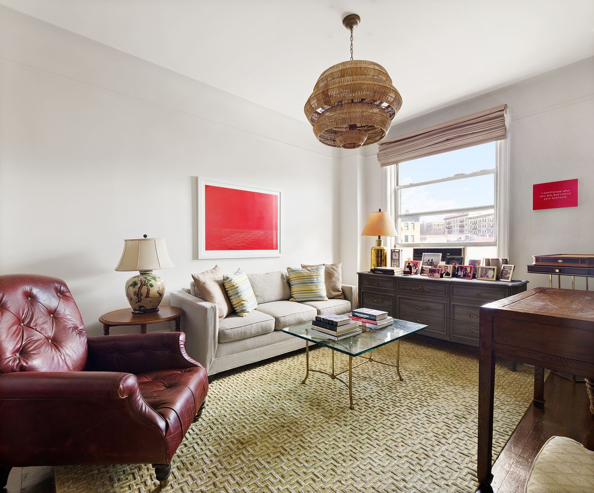 a living room with furniture a chandelier and a table