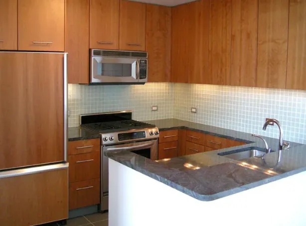 a kitchen with granite countertop a sink stainless steel appliances and cabinets