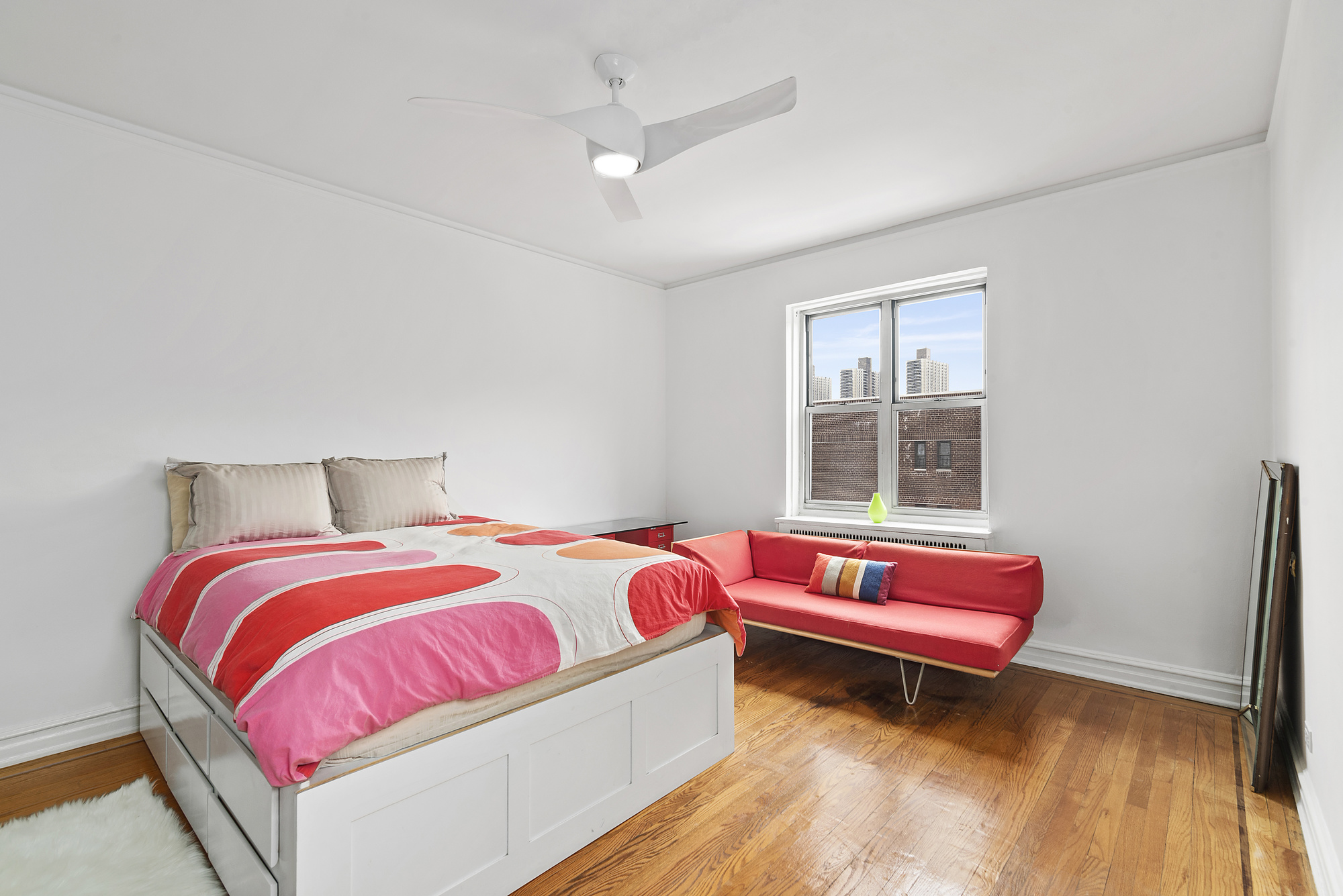 100 Bennett Avenue, Unit 6B Manhattan, NY 10033 - Photo 4 of 5 a bedroom with a bed and a couch