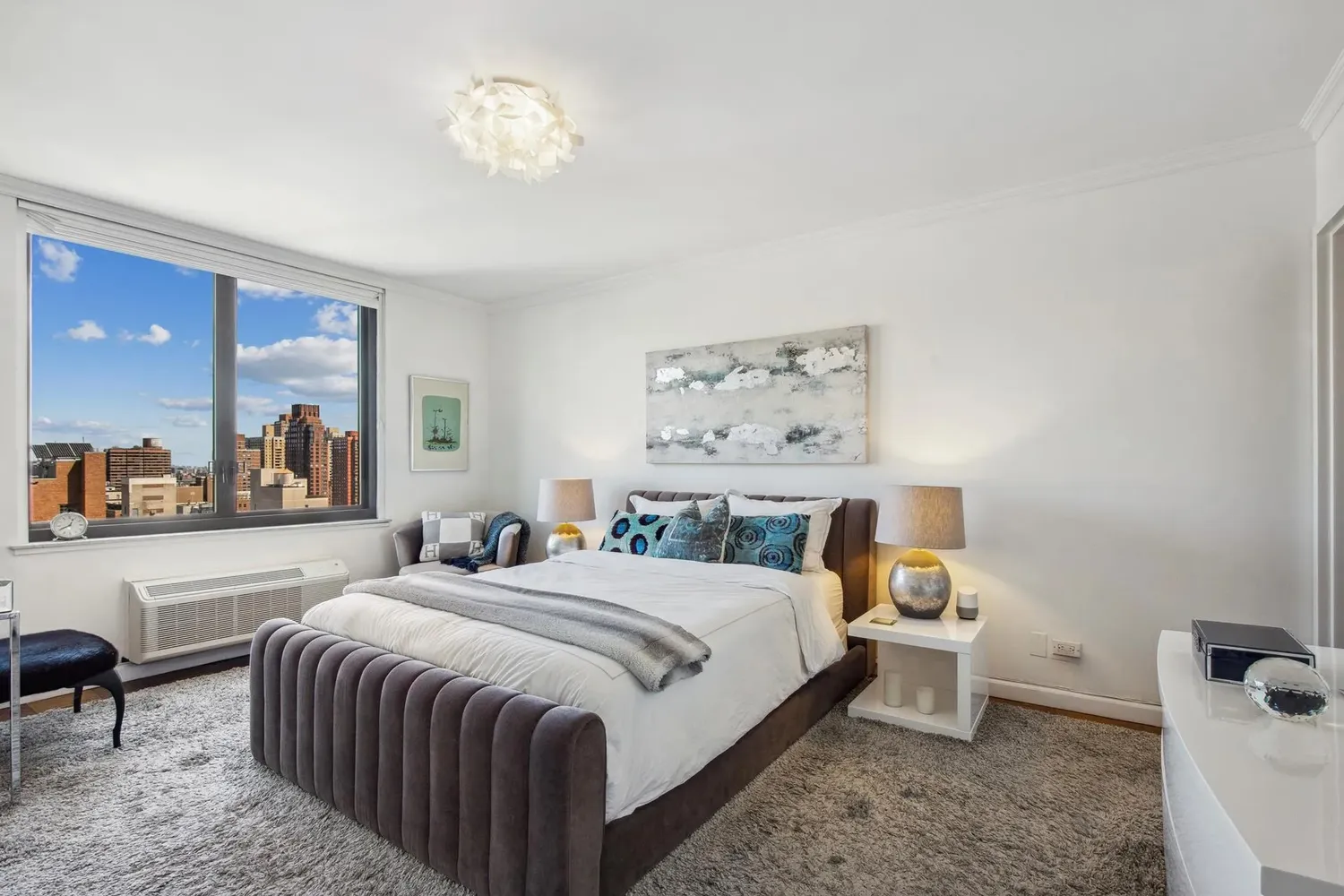 a bedroom with a bed and a painting on the wall