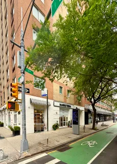 front view of a building with a tree