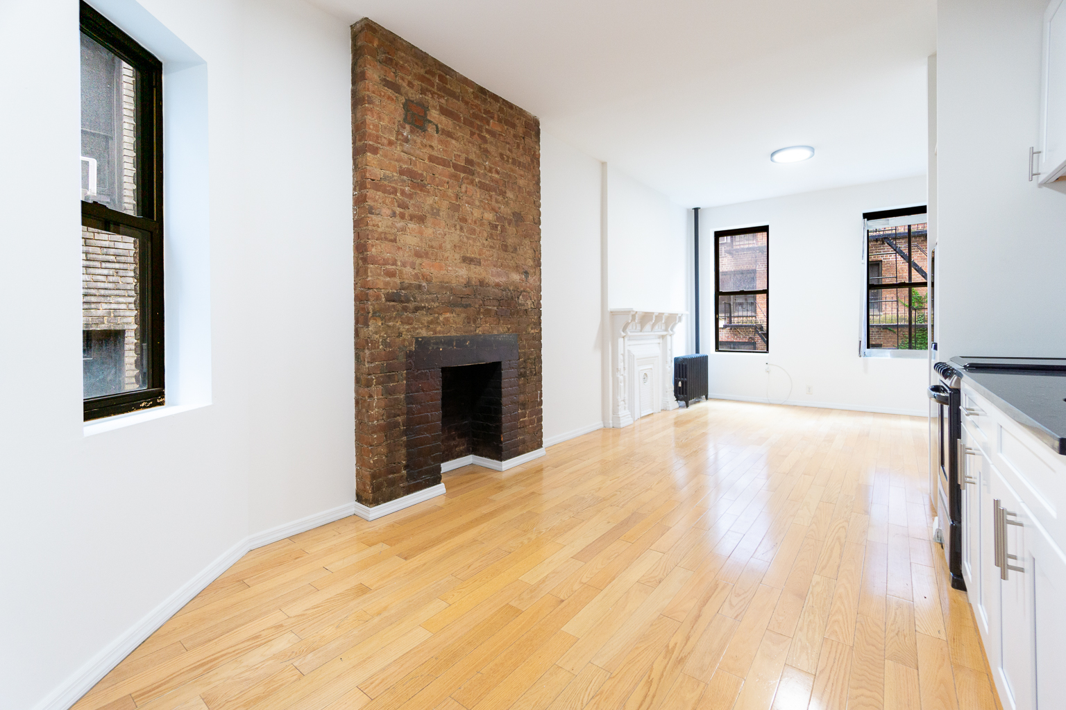 136 East 28th Street, Unit 2RE Manhattan, NY 10016 - Photo 2 of 17 a bed room with a bed and a fireplace
