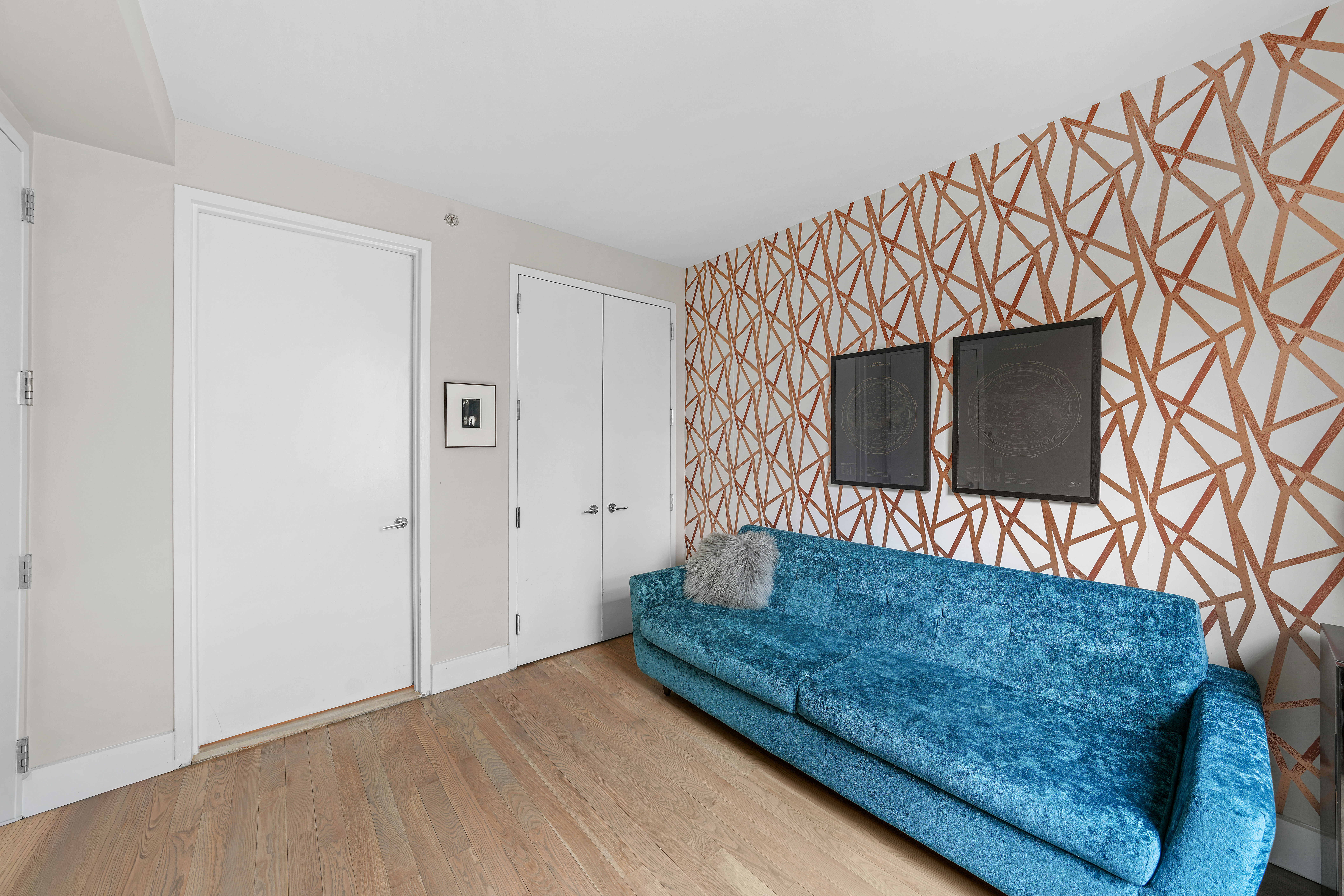 117 West 123rd Street, Unit 1B Manhattan, NY 10027 - Photo 12 of 25 a living room with a couch and a flat screen tv