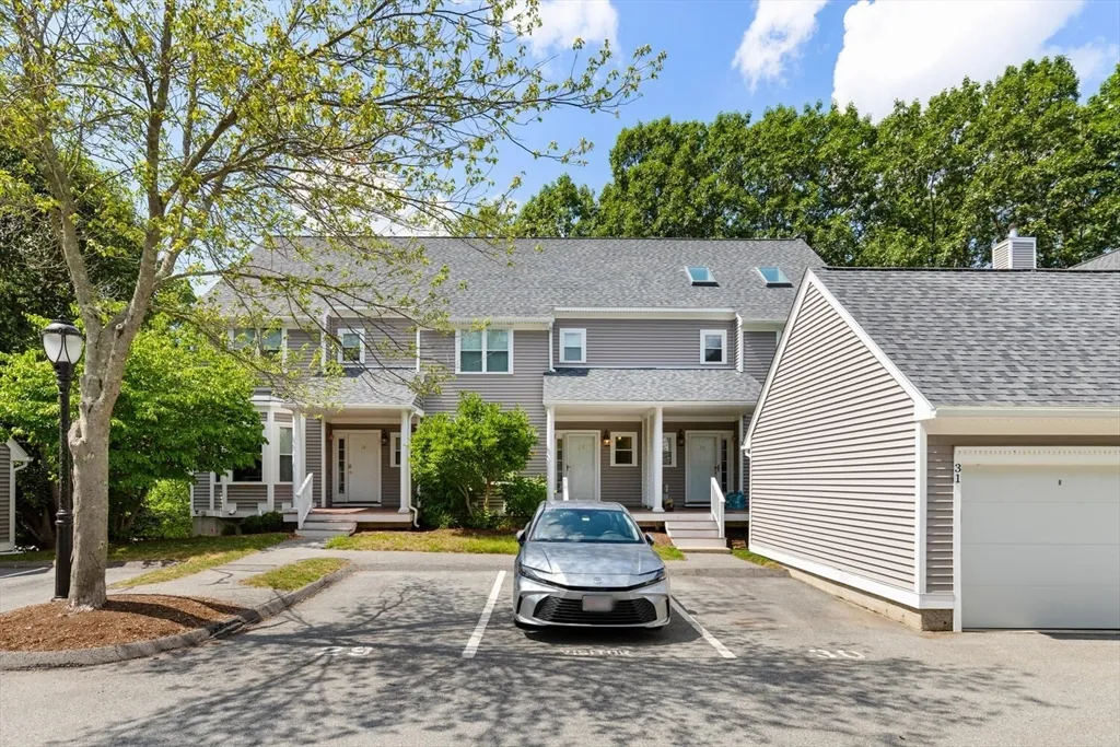 a front view of a house with a yard and trees
