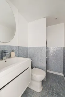 a bathroom with a sink a toilet and a mirror