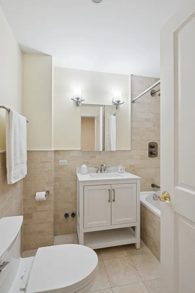 a bathroom with a sink a toilet and mirror