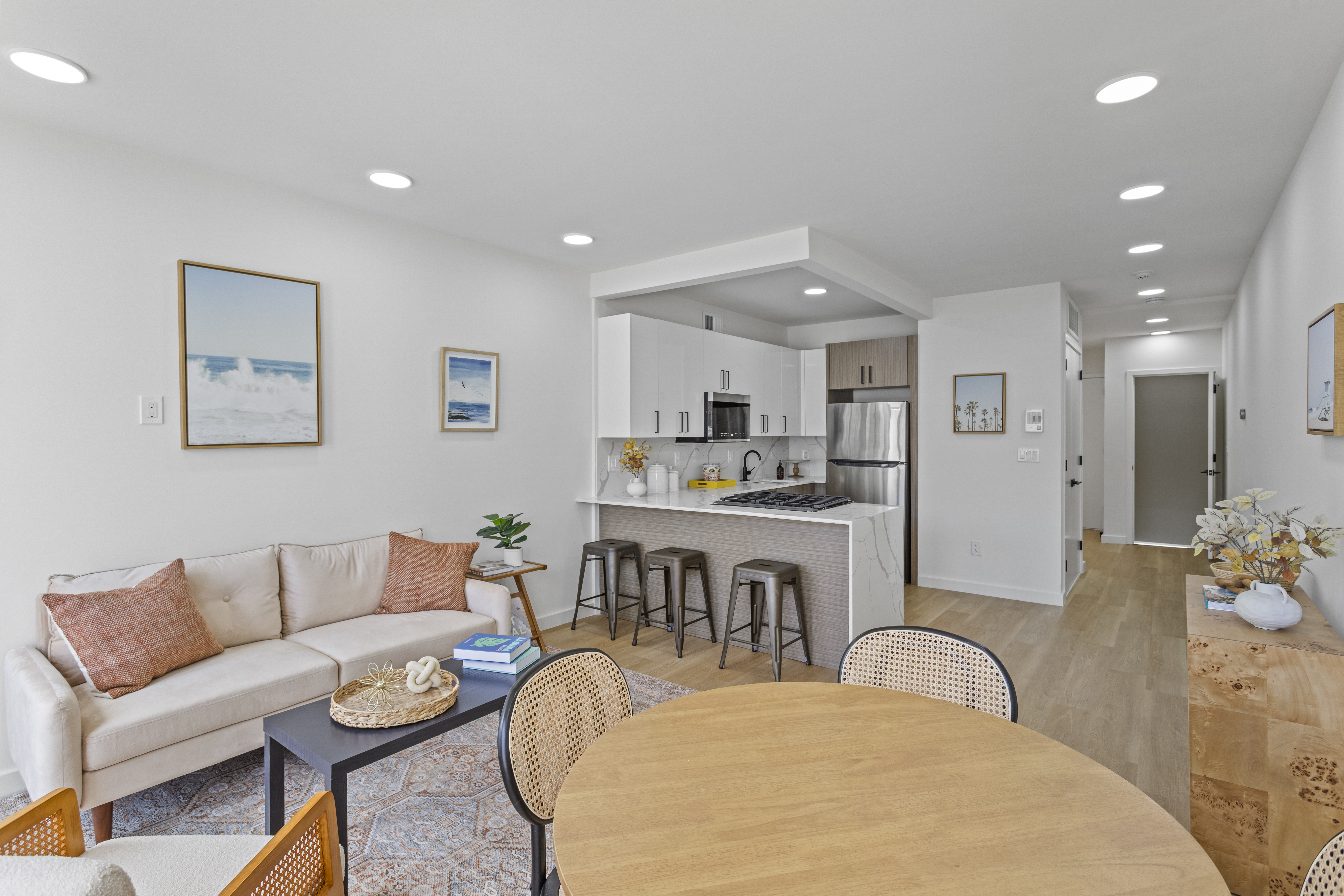 3112 Emmons Avenue, Unit 3140A-2 Brooklyn, NY 11235 - Photo 5 of 13 a living room with furniture kitchen view and a refrigerator