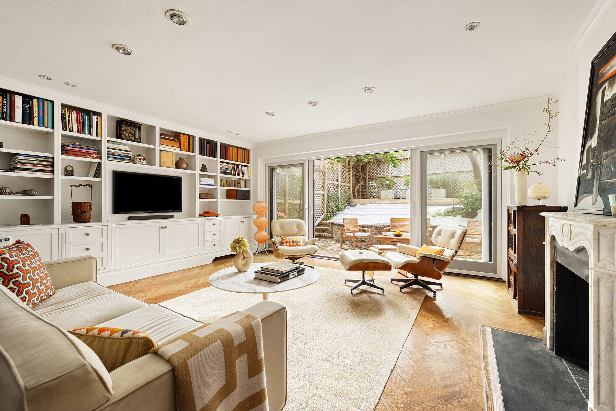 a living room with fireplace furniture and a flat screen tv