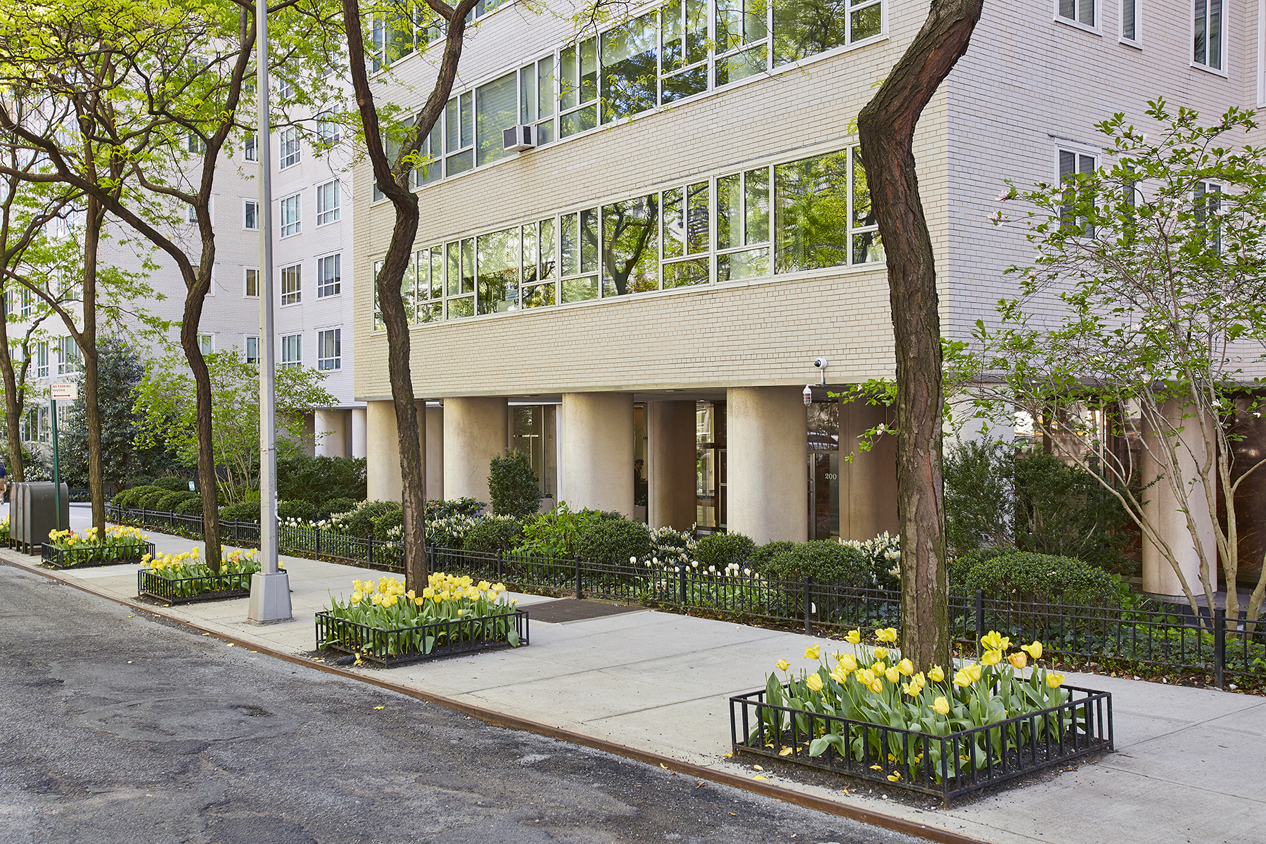 200 East 66th Street, Unit D1004 Manhattan, NY 10065 - Photo 2 of 6 a front view of a house with garden