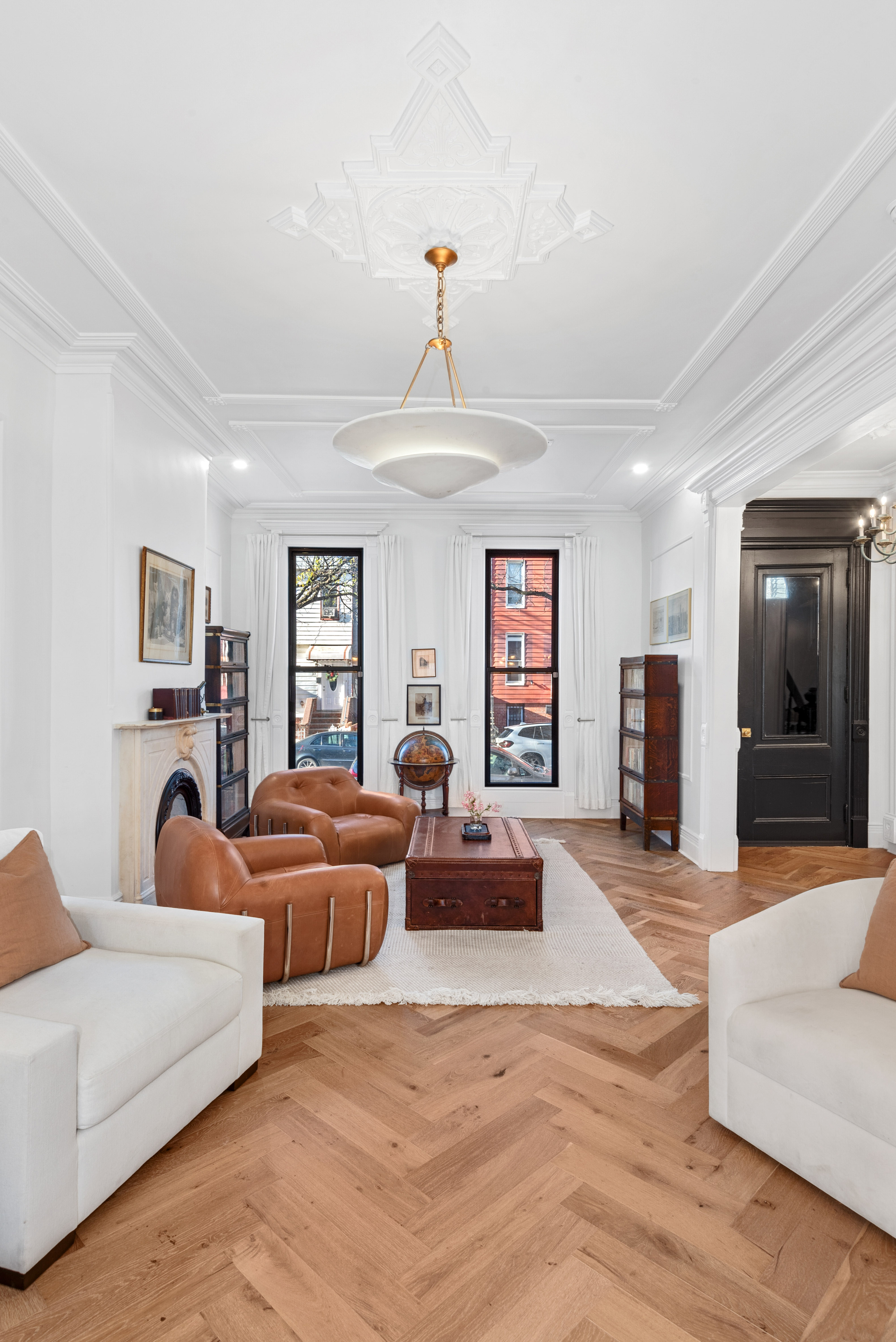 30 Weirfield Street Brooklyn, NY 11221 - Photo 4 of 29 a living room with furniture a chandelier and a flat screen tv