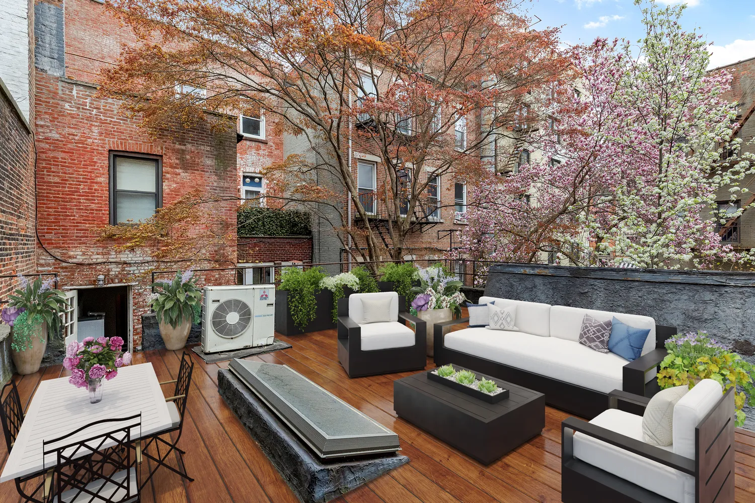 a view of a patio with couches table and chairs with potted plants