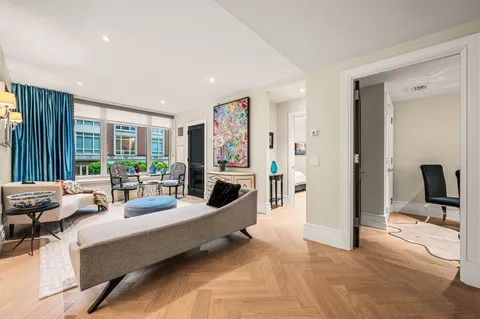 a living room with furniture large window and a flat screen tv