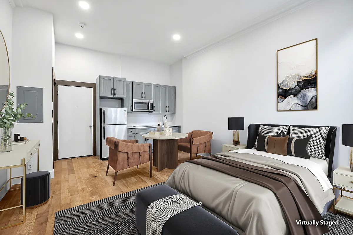 20 East 66th Street, Unit 5B Manhattan, NY 10065 - Photo 1 of 9 a bed room with furniture and a view of kitchen