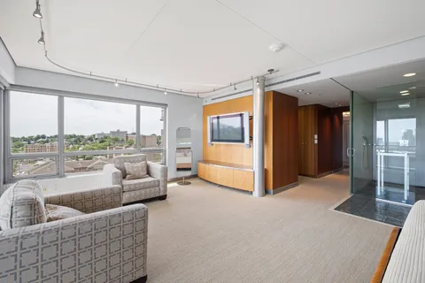 a bedroom with a bed and a potted plant