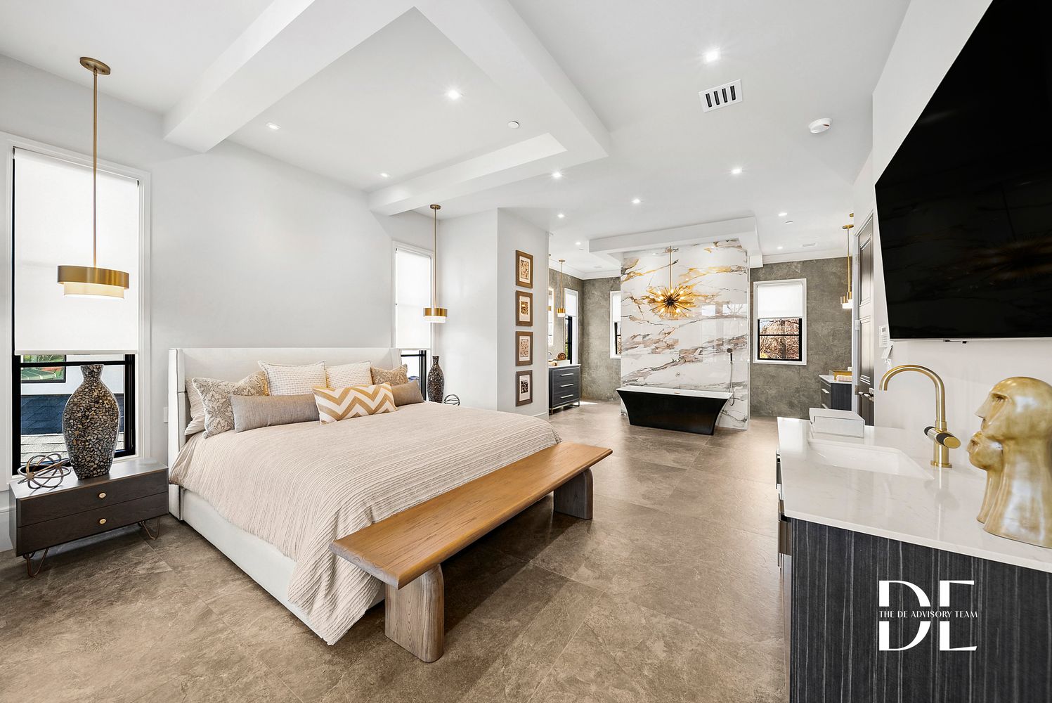 a large bedroom with a bed and a flat screen television