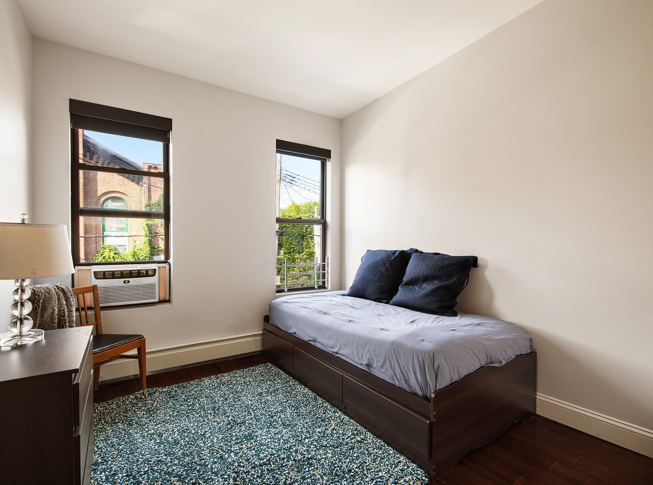 114 Pioneer Street Brooklyn, NY 11231 - Photo 11 of 17 a bed sitting in a bedroom next to a window