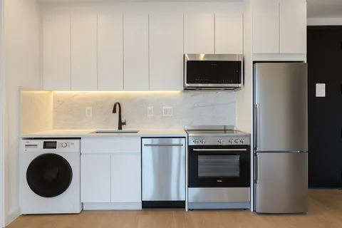 a kitchen with a stove and a refrigerator