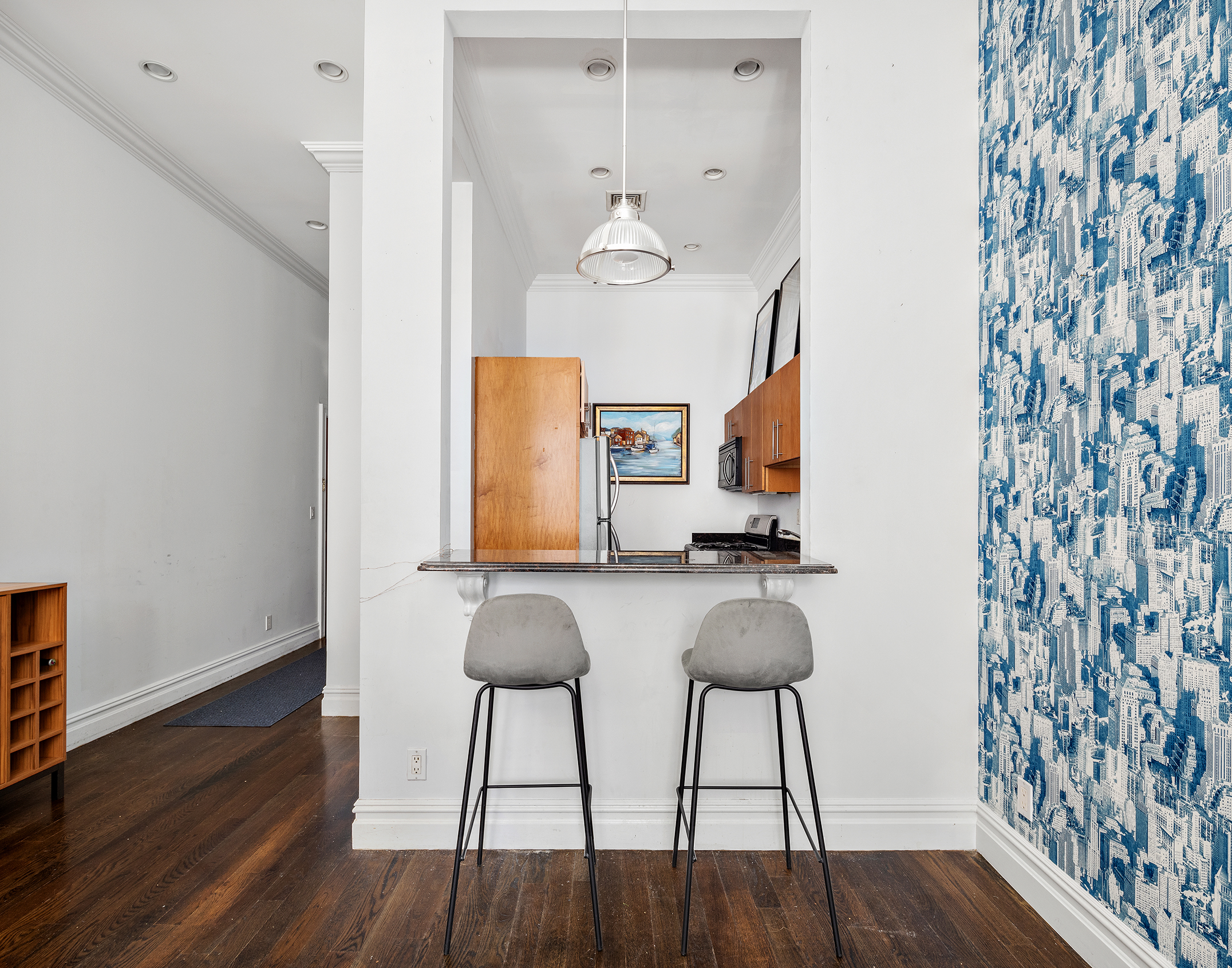 733 9th Avenue, Unit 5 Manhattan, NY 10019 - Photo 3 of 9 a room with furniture and wooden floor