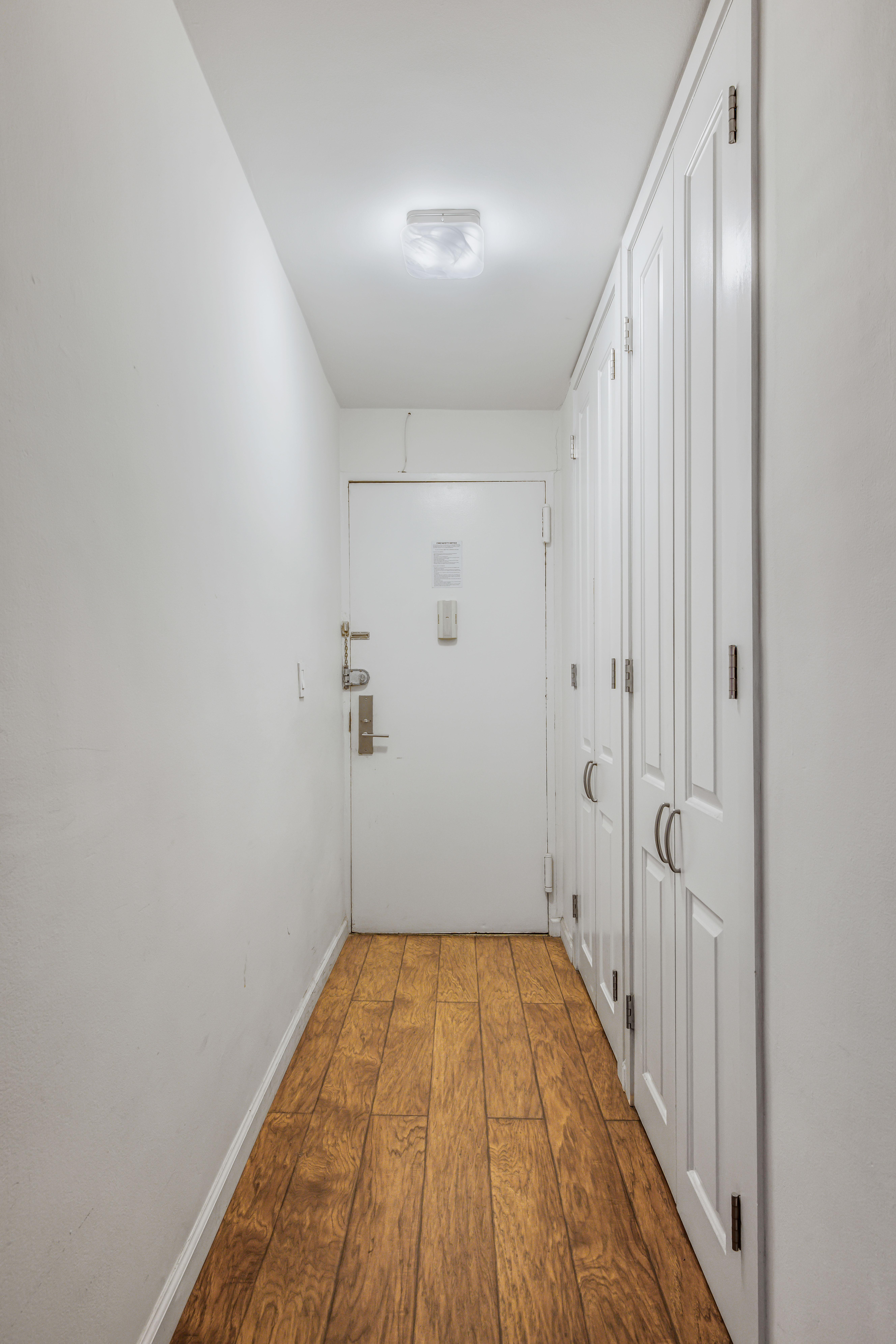 201 East 21st Street, Unit 3K Manhattan, NY 10010 - Photo 6 of 8 a view of a hallway with wooden floor