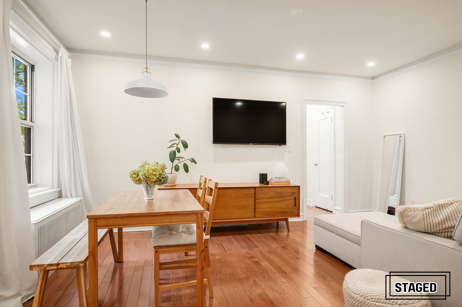 30-31 Hobart Street, Unit 3L Queens, NY 11377 - Photo 6 of 14 a living room with furniture and a flat screen tv