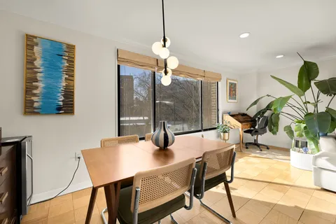 a dining room with furniture and window