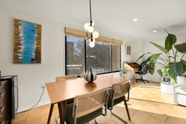 a dining room with furniture and window