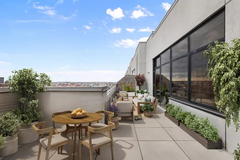 a view of a patio with table and chairs and potted plants