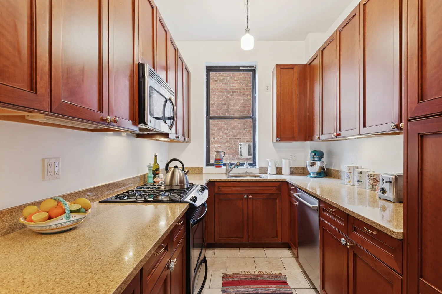 a kitchen with stainless steel appliances granite countertop a sink stove and cabinets