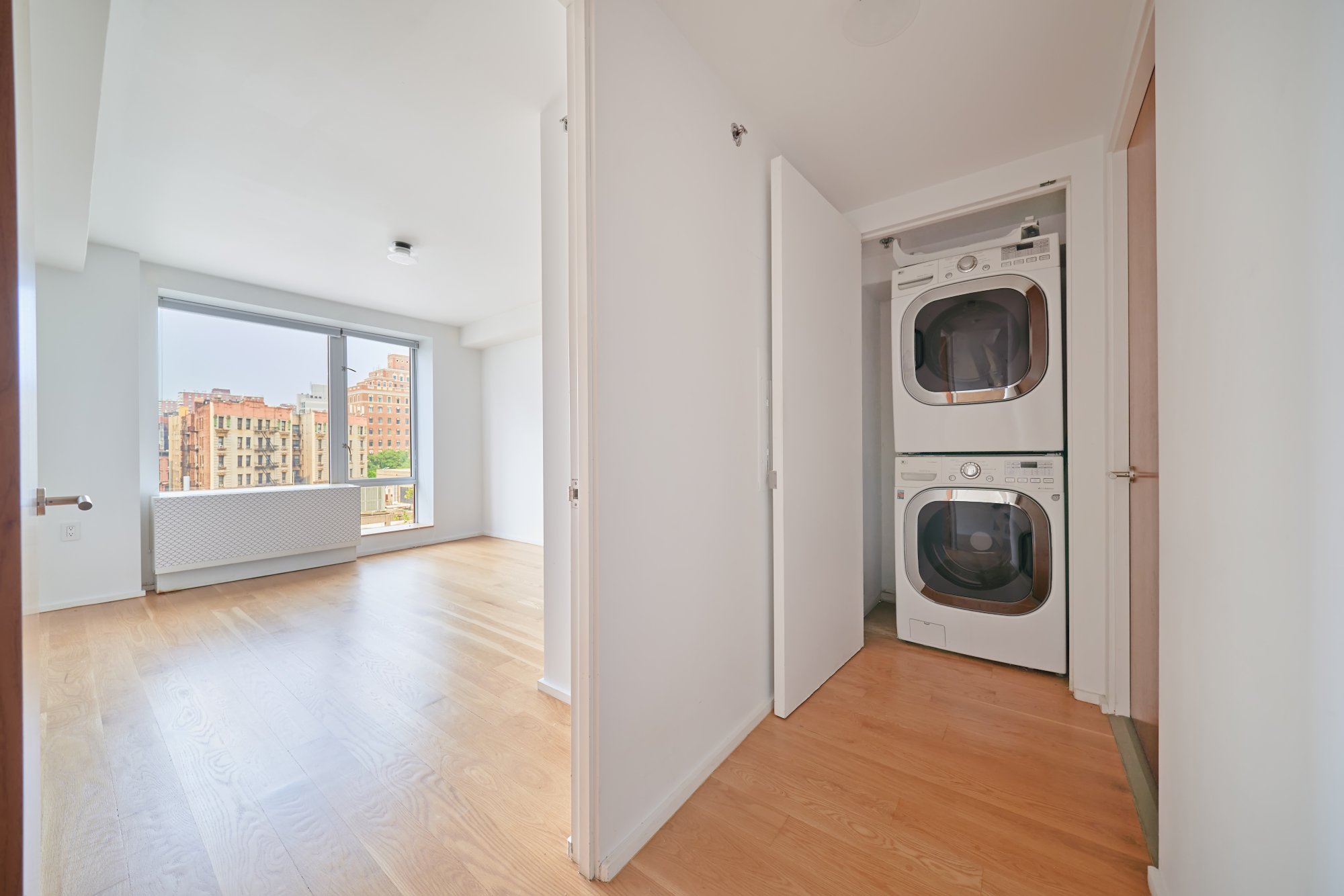2280 Frederick Douglass Boulevard, Unit 5D Manhattan, NY 10027 - Photo 12 of 22 a view of a hallway with washer and dryer