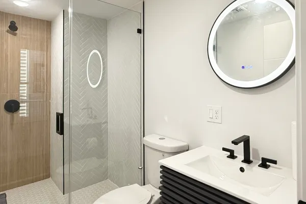 a bathroom with a sink toilet and shower