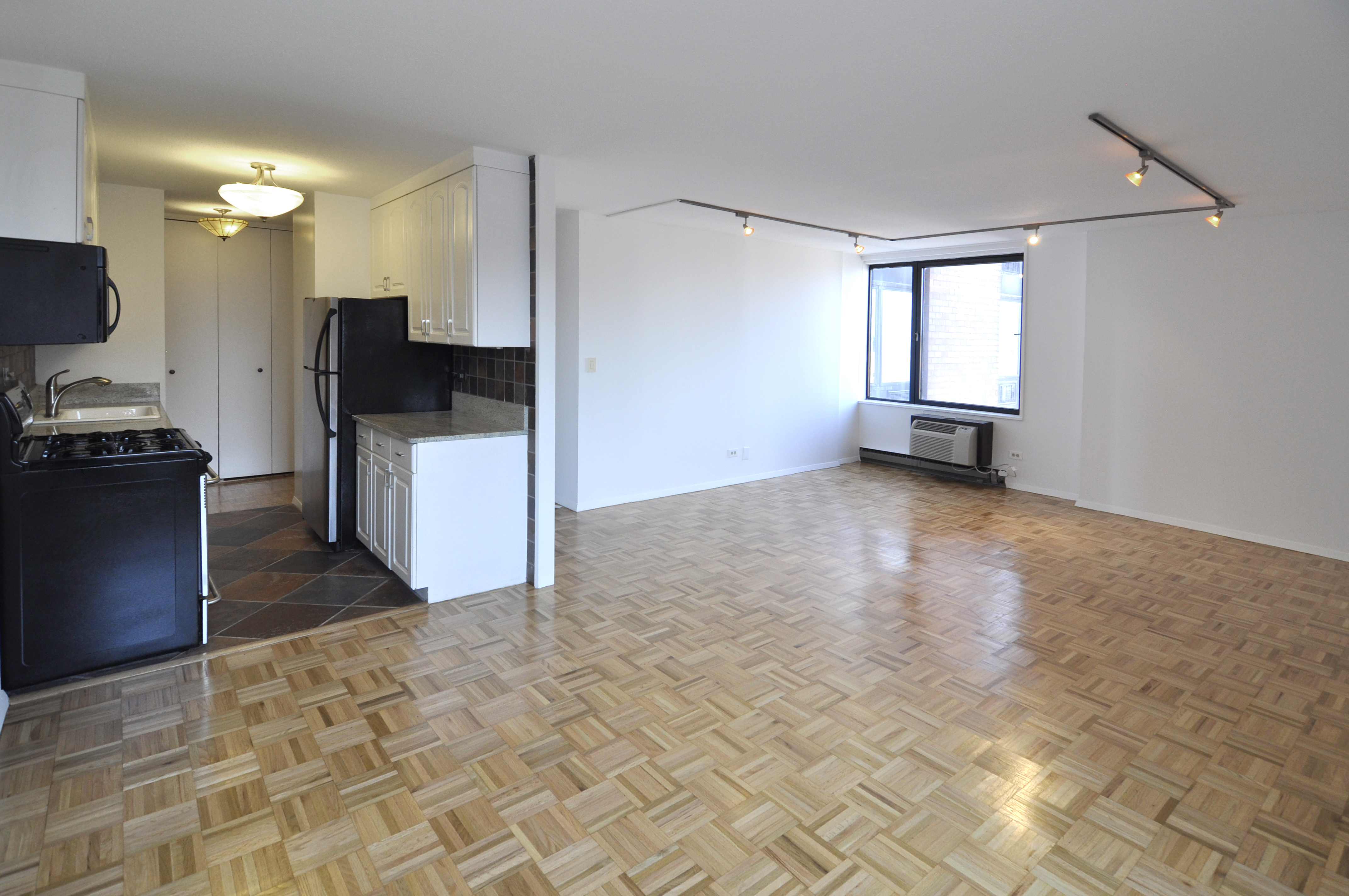 1623 3rd Avenue, Unit 25C Manhattan, NY 10128 - Photo 5 of 12 a view of a kitchen with a sink and a refrigerator