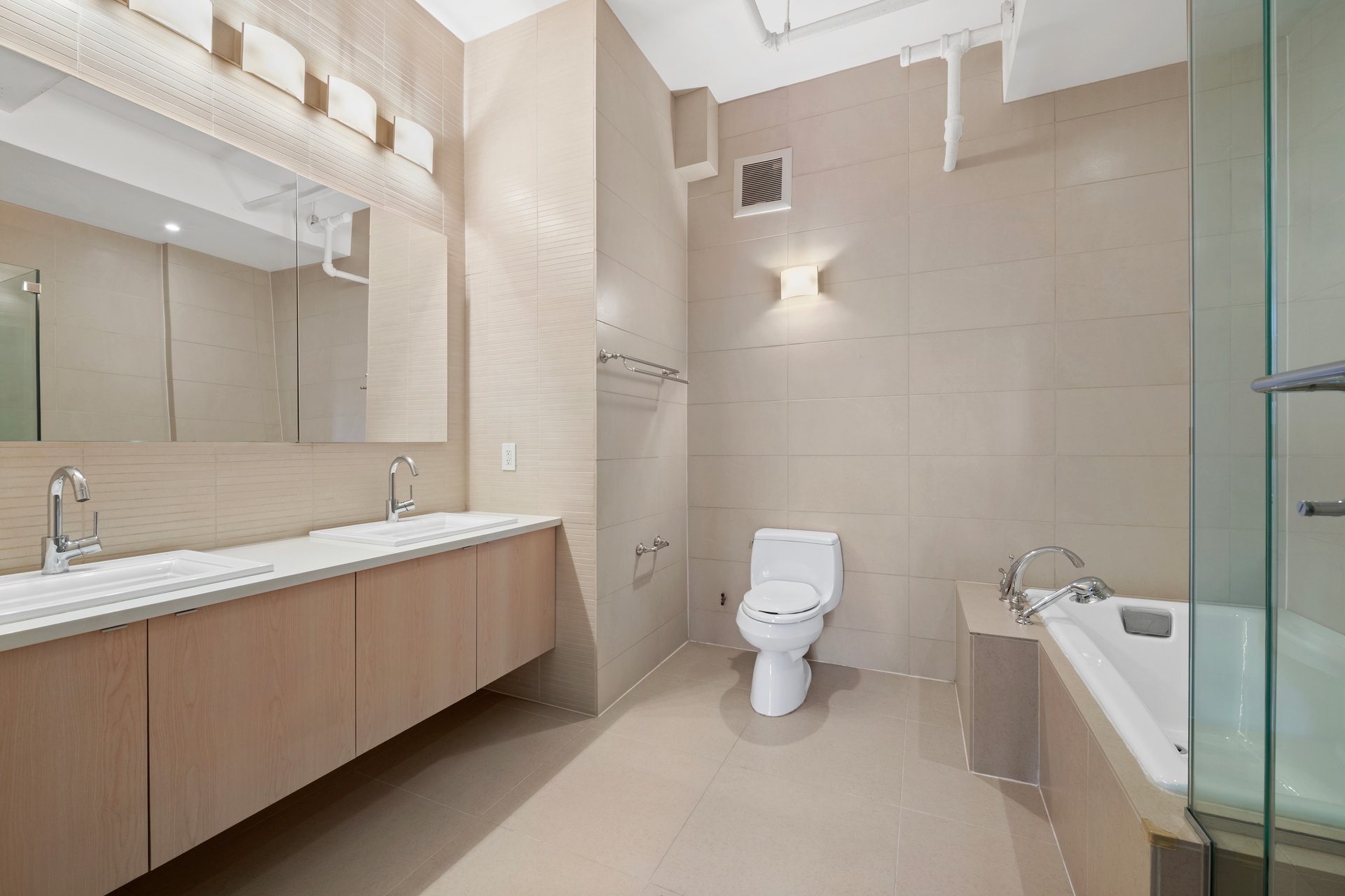 12 West 17th Street, Unit 9 Manhattan, NY 10011 - Photo 5 of 9 a bathroom with a toilet sink and mirror