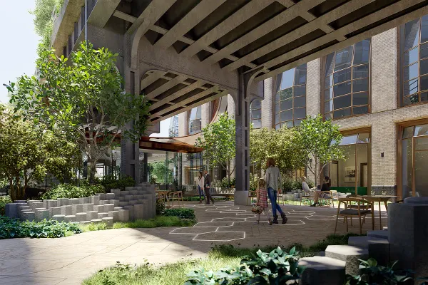 a view of a building with potted plants and large trees