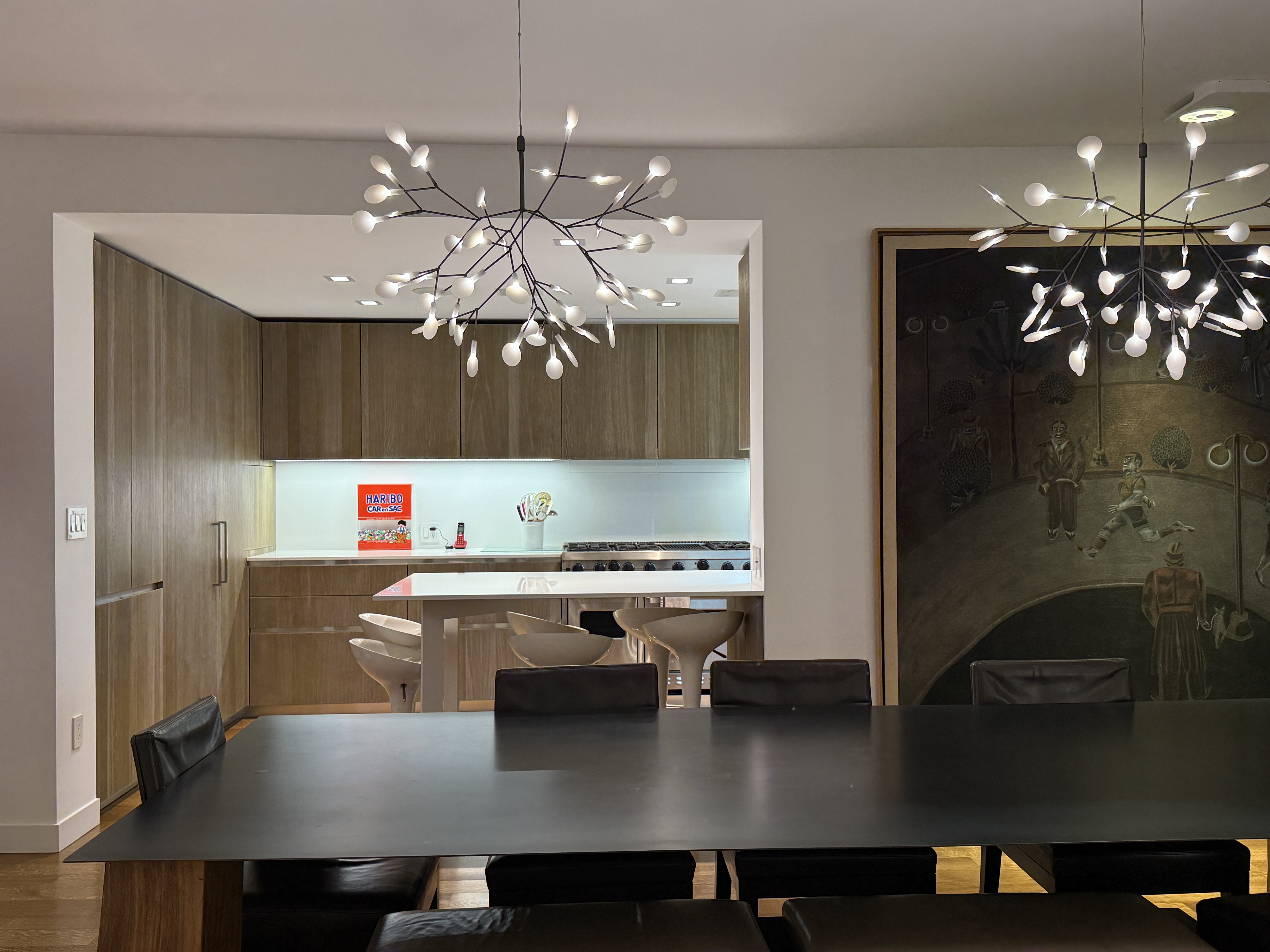 525 East 80th Street, Unit 11BC Manhattan, NY 10075 - Photo 5 of 16 a kitchen with a dining table chairs and chandelier