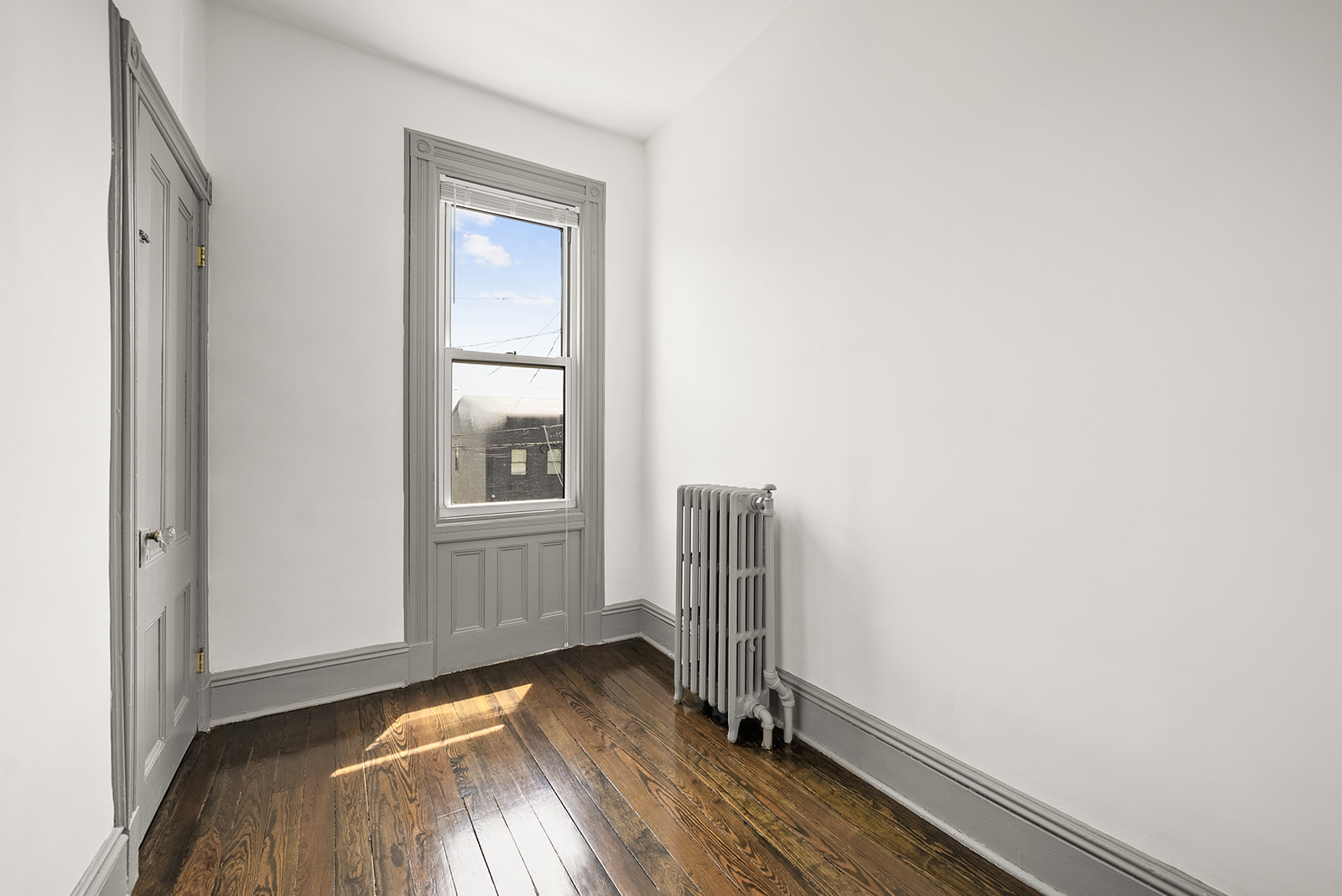 59-45 Palmetto Street Queens, NY 11385 - Photo 17 of 25 a view of room with window and wooden floor