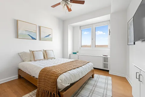 a bedroom with a bed and a painting on the wall