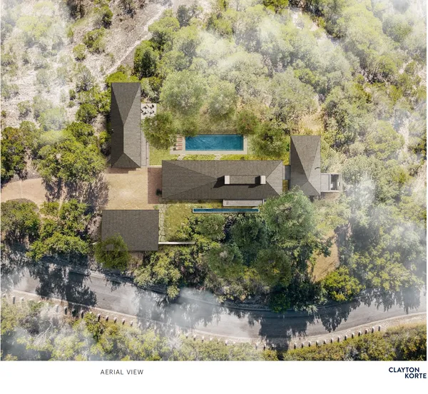 an aerial view of a house with yard and outdoor seating
