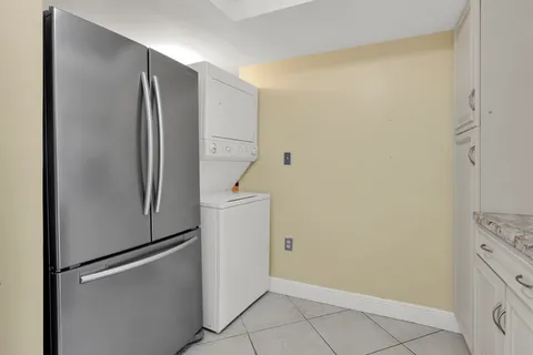 a view of cabinets and refrigerator