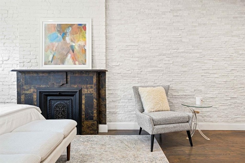 308 Clifton Place Brooklyn, NY 11216 - Photo 25 of 41 a living room with furniture and a fireplace