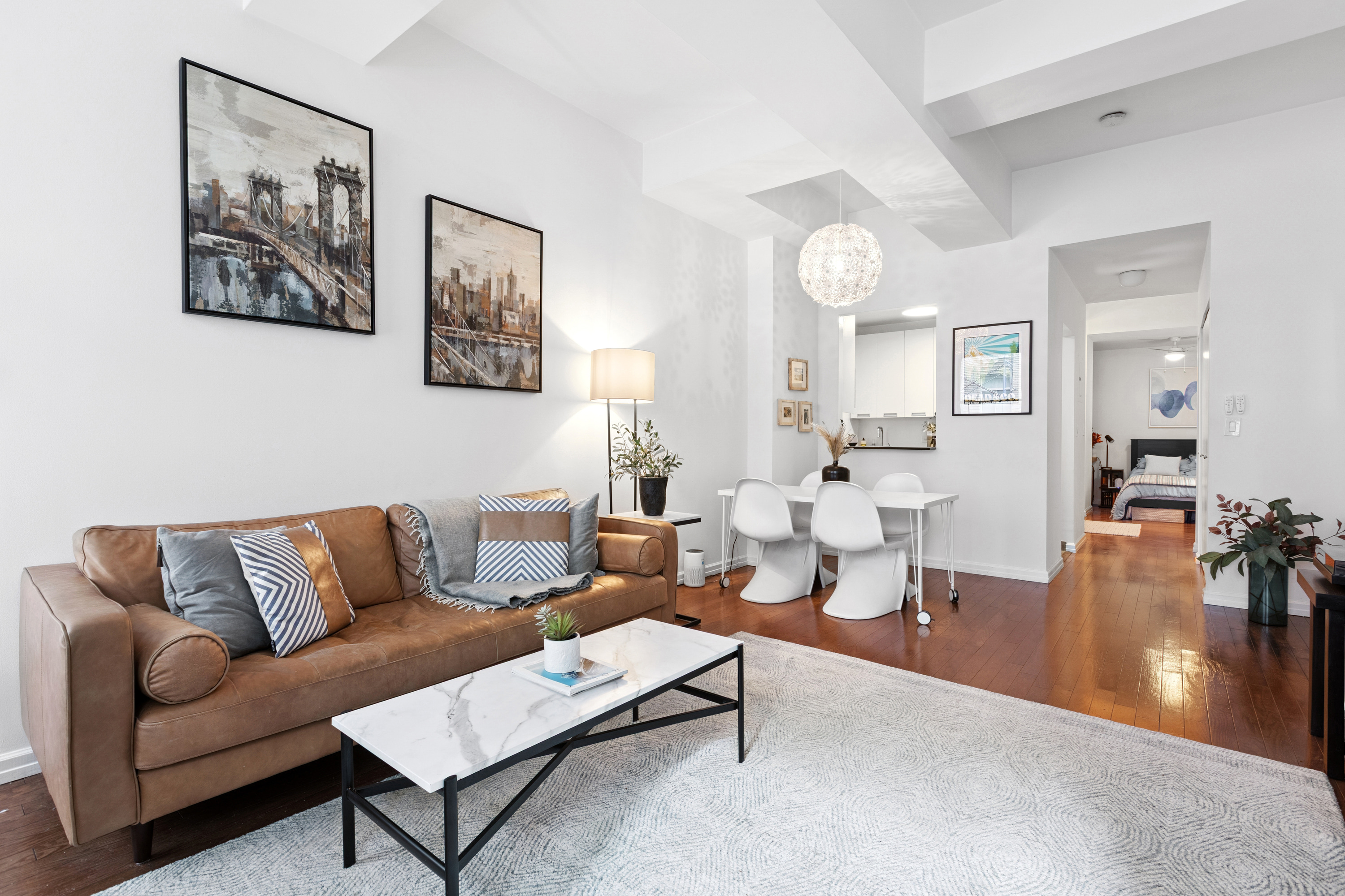 99 John Street, Unit 813 Manhattan, NY 10038 - Photo 2 of 20 a living room with furniture and wooden floor
