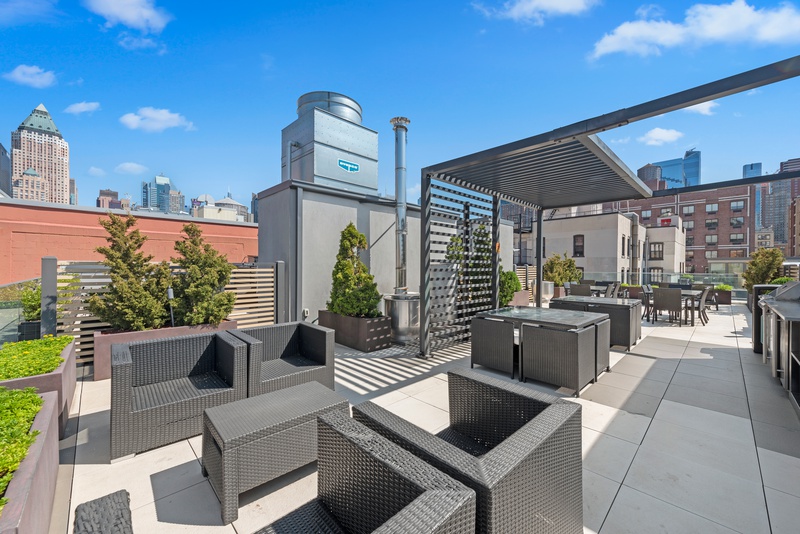 540 West 49th Street, Unit 609N Manhattan, NY 10019 - Photo 7 of 10 a view of kitchen with living room and furniture