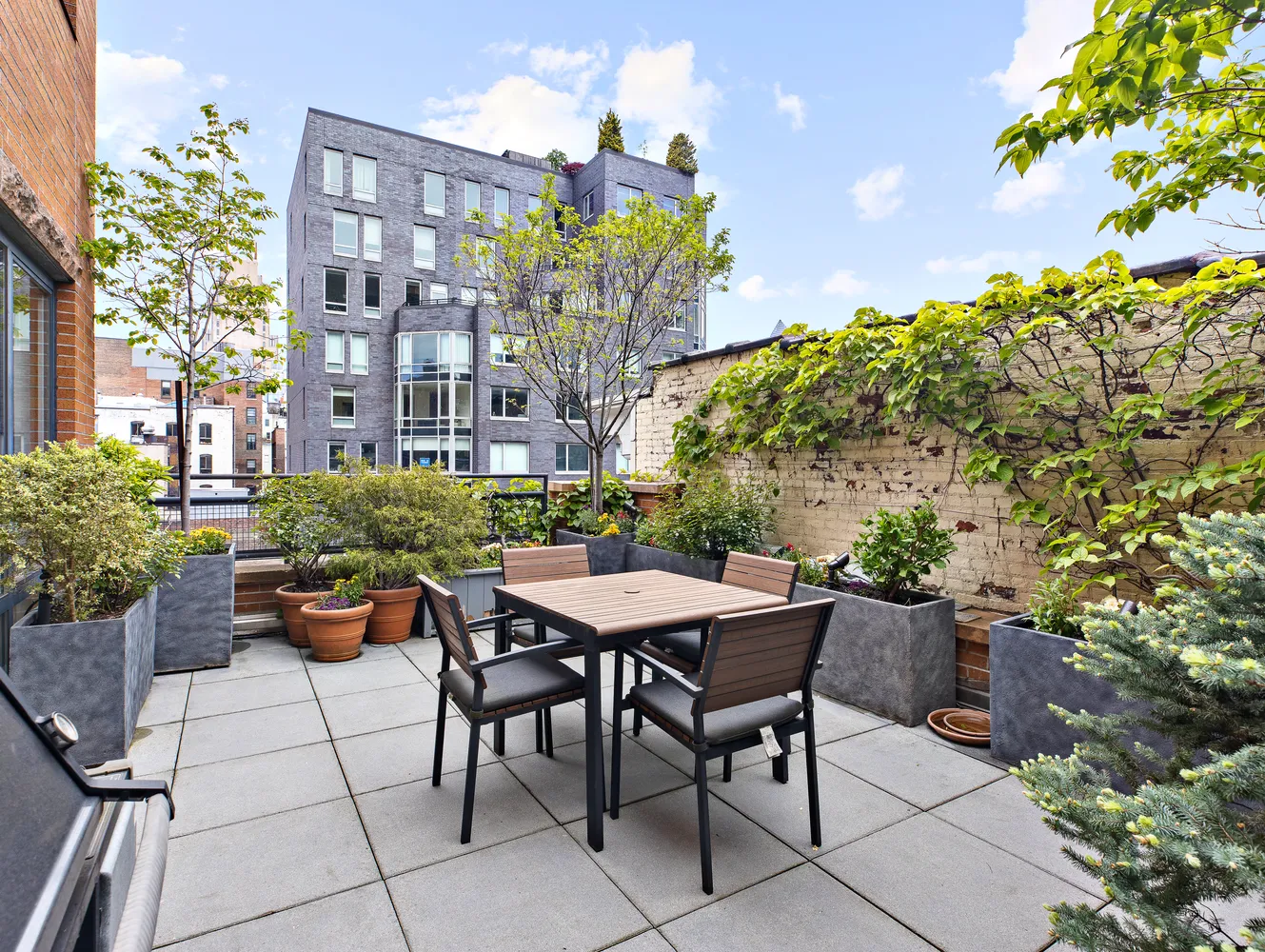 a backyard of a house with a table and chairs