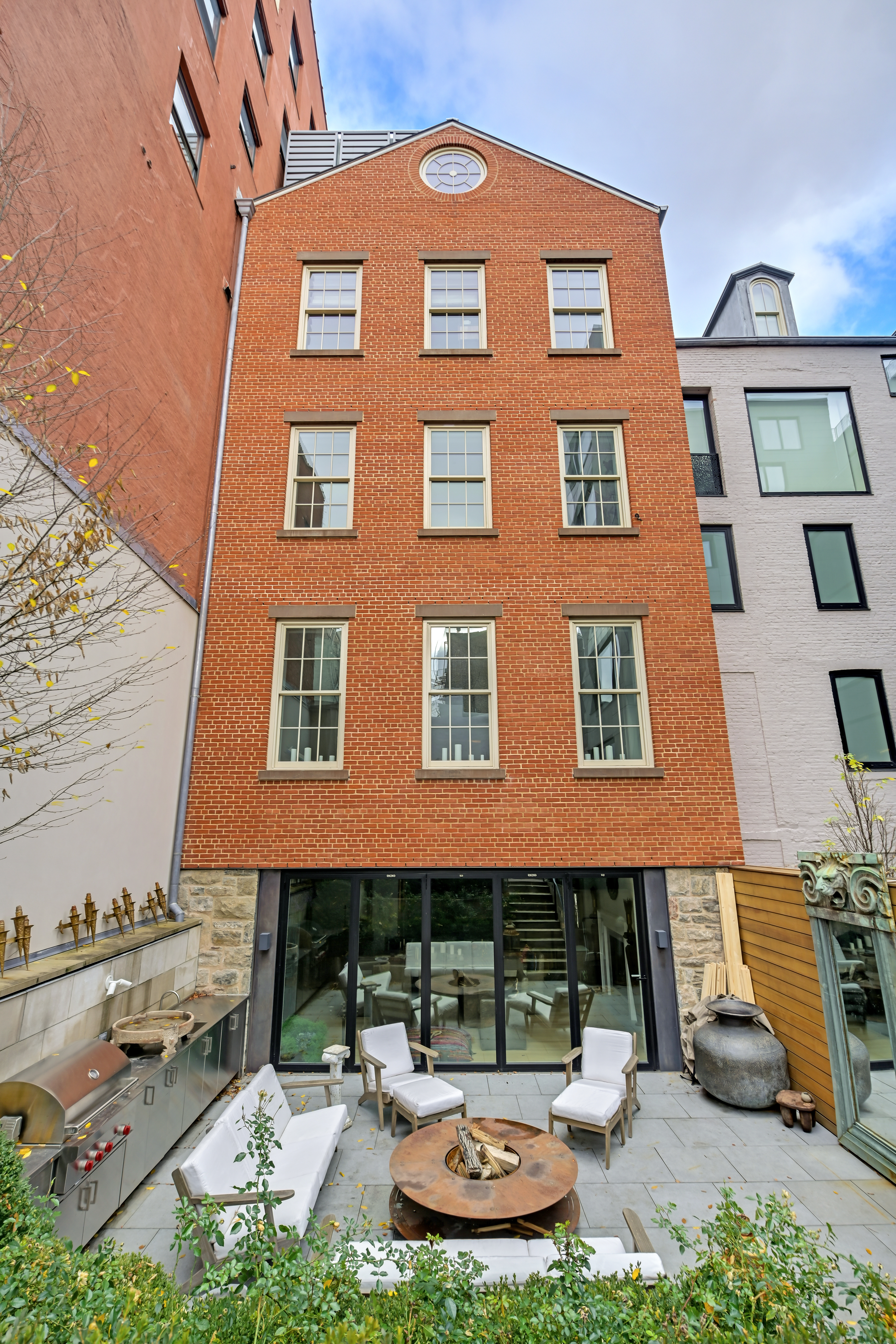 38 Prince Street Manhattan, NY 10012 - Photo 2 of 17 a front view of a building with garage and a fountain