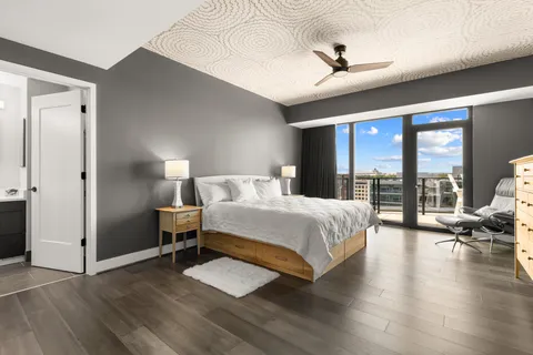 a bedroom with a bed and wooden floor