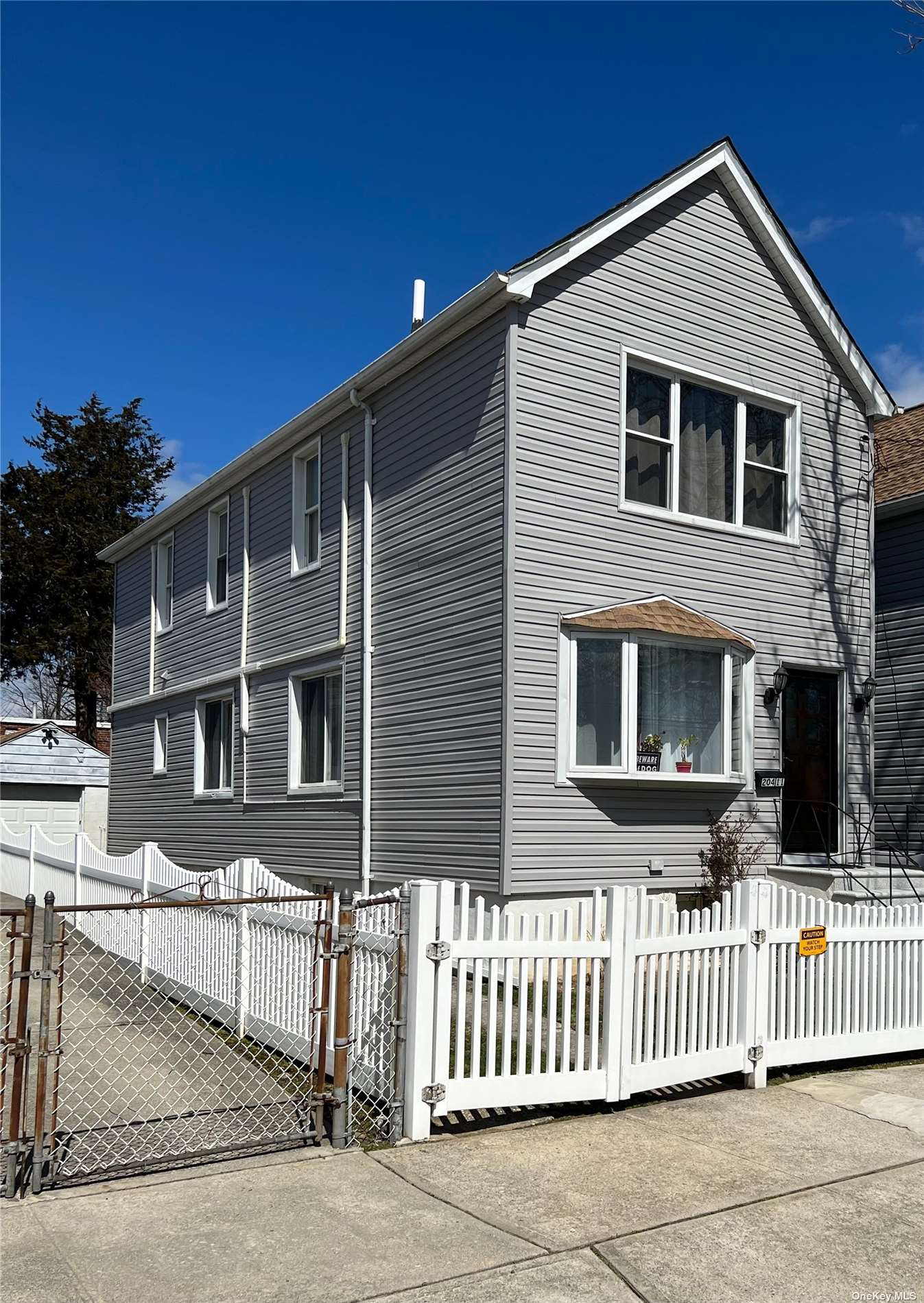 204-11 46th Avenue Queens, NY 11361 - Photo 2 of 7 a front view of a house with a porch