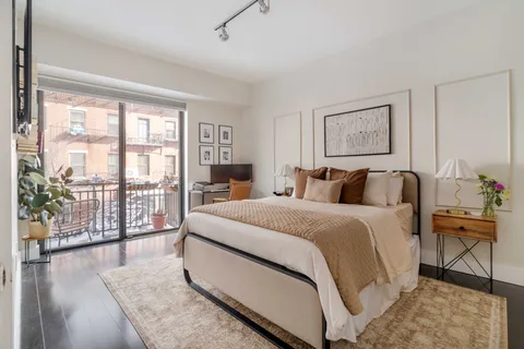 a bed room with a bed and a large window